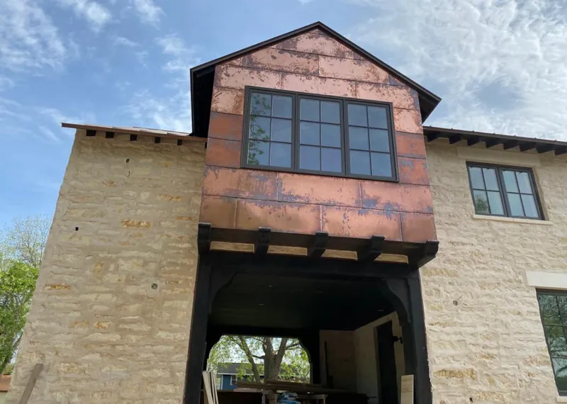 Copper metal panel facade on a stone building for Metal Roof Coating in Melrose